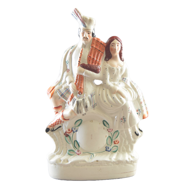 Staffordshire figur i fajance med funktion som holder til lommeur. Staffordshire i England.